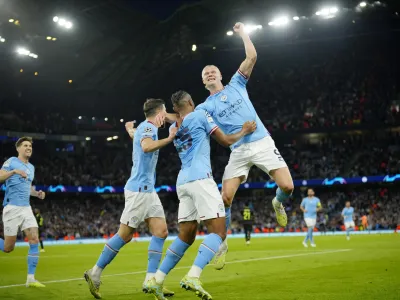 Manchester City's Erling Haaland, right, and his teammates celebrate their third goal during the Champions League semifinal second leg soccer match between Manchester City and Real Madrid at Etihad stadium in Manchester, England, Wednesday, May 17, 2023. (AP Photo/Jon Super)