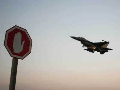 An Israeli Air Force F-16 fighter plane flying above a traffic sign after taking off for a mission in Lebanon from an Israeli Air Force Base in northern Israel in this July 20, 2006 file photo. Israeli warplanes bombed unidentified Syrian targets early on September 6, 2007, causing no damage or casualties, the official Syrian news agency said. Syrian air defences fired at the incoming planes, which crossed into Syria after midnight local time, the agency said. REUTERS/Ammar Awad/Files (ISRAEL)