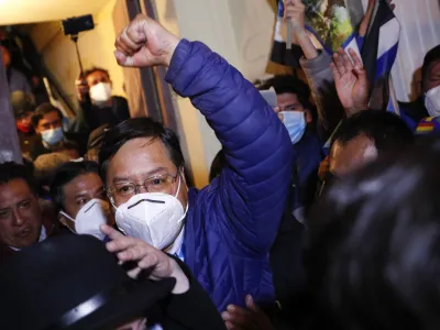 ﻿Luis Arce, presidential candidate for the Movement Towards Socialism (MAS) party, raises his fist as he claims victory after general elections in La Paz, Bolivia, Monday, Oct. 19, 2020. (AP Photo/Juan Karita)