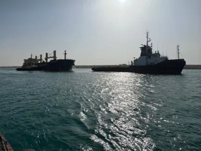 A general view of two tugboats working to refloat a large ship that ran aground at the canal of Ismailia, Egypt, May 25, 2023. The Suez Canal Authority/Handout via REUTERS THIS IMAGE HAS BEEN SUPPLIED BY A THIRD PARTY.