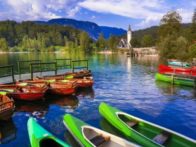 amazing nature and beautiful lakes of Slovenia - Bohinj. view with small monastery and boats