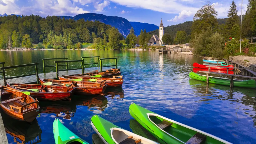 amazing nature and beautiful lakes of Slovenia - Bohinj. view with small monastery and boats