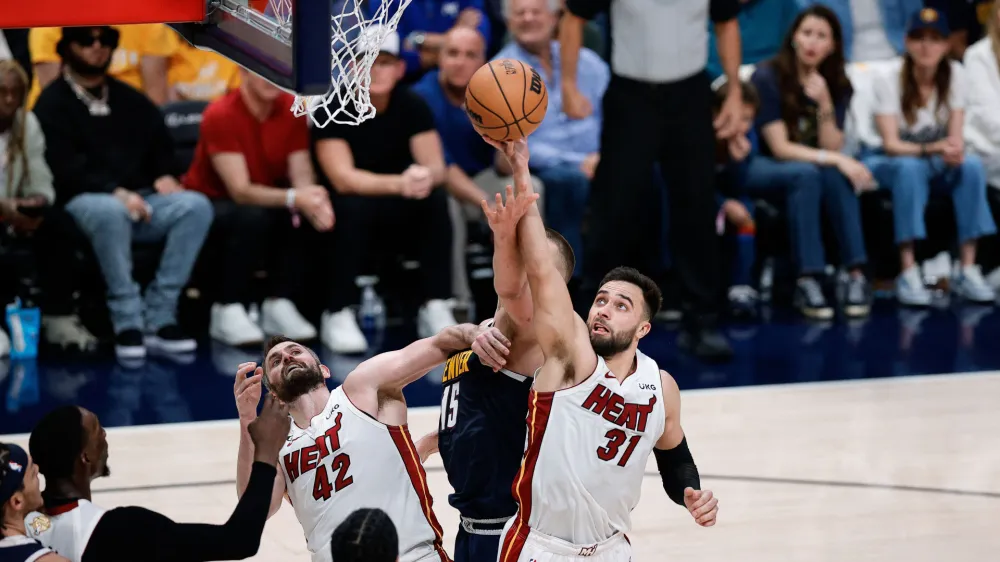 Jun 4, 2023; Denver, CO, USA; Miami Heat guard Max Strus (31) battles for a rebound with Denver Nuggets center Nikola Jokic (15) as forward Kevin Love (42) defends in the third quarter in game two of the 2023 NBA Finals at Ball Arena. Mandatory Credit: Isaiah J. Downing-USA TODAY Sports