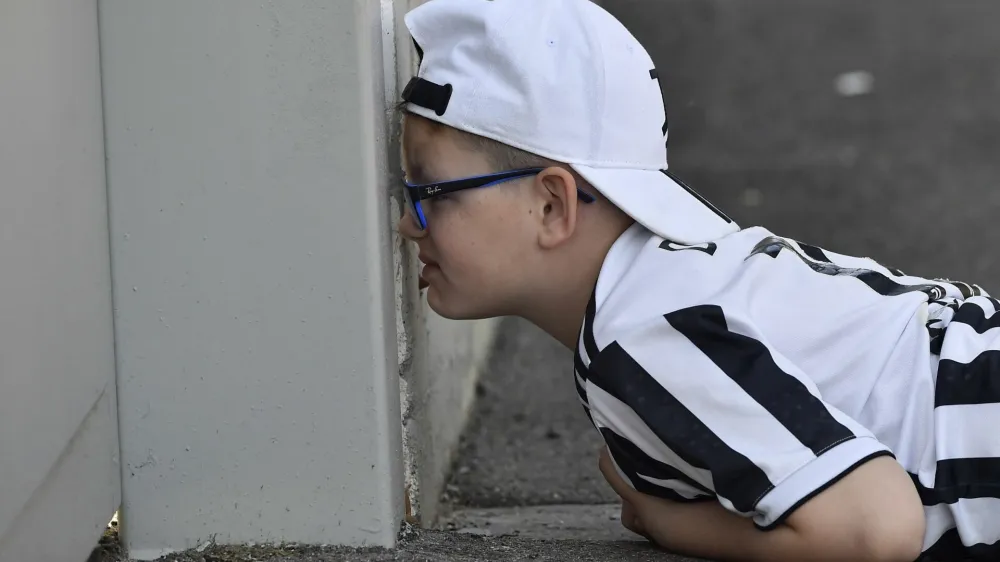 Soccer Football - Europa League - Juventus Training - Juventus Training Centre, Turin, Italy - April 19, 2023 A young Juventus fan watches the training from outside REUTERS/Massimo Pinca