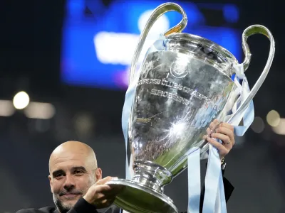 Manchester City's head coach Pep Guardiola holds the trophy after winning the Champions League final soccer match between Manchester City and Inter Milan at the Ataturk Olympic Stadium in Istanbul, Turkey, Sunday, June 11, 2023. Manchester City won 1-0. (AP Photo/Francisco Seco)