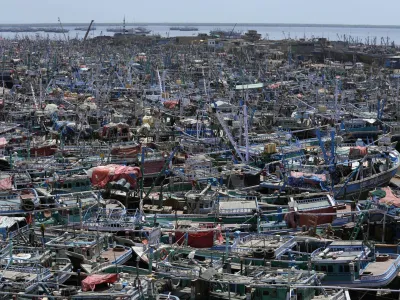 Fishing boats are anchored at a fishing harbor following authorities alerting fishermen of Cyclone Tauktae, in Karachi, Pakistan, Saturday, June 10, 2023. The meteorological department issued an alert, warning fishermen to avoid fishing in the Arabian sea, as the Cyclone Tauktae could cause rough conditions in the sea. (AP Photo/Fareed Khan)