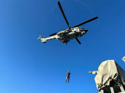 A undated handout photo provided by the Hellenic Coast Guard shows a helicopter during a rescue operation to save migrants onboard a boat, before it capsized at open sea, off Greece. Hellenic Coast Guard/Handout via REUTERS ATTENTION EDITORS - THIS IMAGE HAS BEEN SUPPLIED BY A THIRD PARTY.