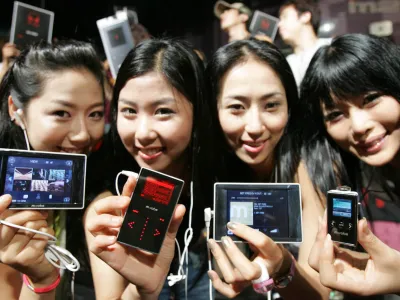  South Korean models display latest MP3 players, MR-500i, left, MR-100, second from left, and MR-F10, right, developed by Olympus during a product release ceremony in Seoul, Thursday, June 30, 2005. Olympus Korea Co. is marketing five types of new MP3 products priced between 149,000 won (145 USD) and 349,000 won (340 USD) to broaden its business base in South Korea.  (AP Photo/Ahn Young-joon).