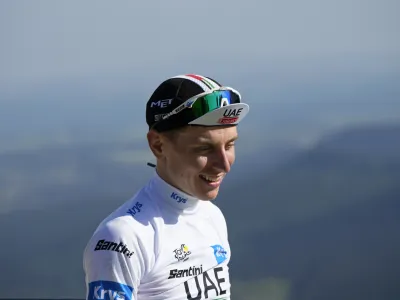 Slovenia's Tadej Pogacar, wearing the best young rider's white jersey, smiles on the podium of the ninth stage of the Tour de France cycling race over 182.5 kilometers (113.5 miles) with start in Saint-Leonard-de-Noblat and finish in Puy de Dome, France, Sunday, July 9, 2023. (AP Photo/Daniel Cole)