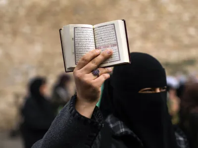 FILE - A woman holds up a Quran during a protest outside the Swedish consulate in Istanbul, Turkey, on Jan. 22, 2023. Turkish President Recep Tayyip Erdogan's abrupt approval of Sweden's NATO bid came after a year of objections to Stockholm to joining the defense alliance. (AP Photo/Francisco Seco, File)