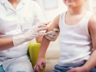 Pediatrician makes vaccination to small boy