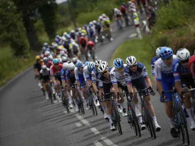 Netherlands' sprinter Fabio Jakobsen, in sixth position with white jersey, follows his teammates during the eleventh stage of the Tour de France cycling race over 180 kilometers (112 miles) with start in Clermont-Ferrand and finish in Moulins, France, Wednesday, July 12, 2023. (AP Photo/Daniel Cole)