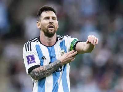 FILED - 26 November 2022, Qatar, Lusail: Argentina's Lionel Messi pushes up his captain's armband. World Cup champion Lionel Messi is feeling ready for his new life in the United States following a transfer from Paris Saint-Germain to Inter Miami. Photo: Tom Weller/dpa