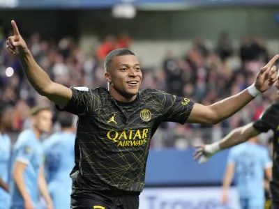 FILE - PSG's Kylian Mbappe celebrates after scoring his side's opening goal during the French League One soccer match between Troyes and Paris Saint Germain, at the Stade de l'Aube, in Troyes, France, Sunday, May 7, 2023. Saudi Arabian soccer team Al-Hilal has made a record 2 million bid for France striker Kylian Mbappe. Paris Saint-Germain has confirmed the offer and says it has given Al-Hilal permission to open negotiations directly with Mbappe. (AP Photo/Lewis Joly, File)