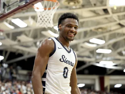 FILE - Sierra Canyon's Bronny James (0) smiles during a high school basketball game against Christopher Columbus at the Hoophall Classic, Monday, Jan. 16, 2023, in Springfield, Mass. Bronny James, son of NBA superstar LeBron James, was hospitalized after going into cardiac arrest while participating in a practice at Southern California on Monday, July 24, 2023. (AP Photo/Gregory Payan, File)