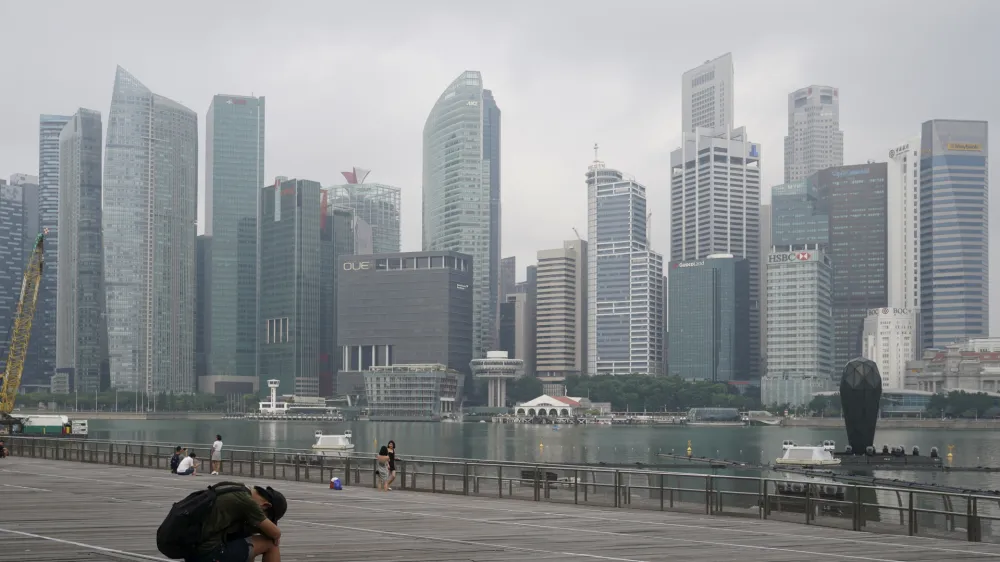 FILE - A man takes a nap as the central business district is shrouded by haze in Singapore, on Sept. 23, 2019. Singapore executed a man Wednesday, July 26, 2023, for drug trafficking and is set to hang a woman Friday — the first in 19 years — prompting renewed calls for a halt to capital punishment. (AP Photo/Vincent Thian, File)