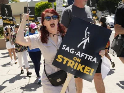 Kate Flannery appears on a picket line outside Paramount studios on Wednesday, July 26, 2023, in Los Angeles. The actors strike comes more than two months after screenwriters began striking in their bid to get better pay and working conditions. (AP Photo/Chris Pizzello)