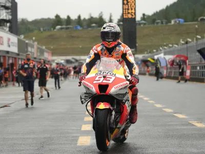 Spanish MotoGP rider Marc Marquez returns to the pitlane after taking pole position during the qualifying round of the Japanese Motorcycle Grand Prix at the Twin Ring Motegi circuit in Motegi, north of Tokyo Saturday, Sept. 24, 2022.(AP Photo/Shuji Kajiyama)