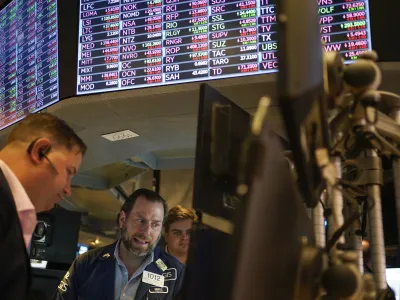 FILE - Traders work on the floor at the New York Stock Exchange in New York, May 19, 2022. Stocks are opening lower on Wall Street Tuesday, May 24, 2022 led by drops in tech heavyweights like the parent companies of Facebook and Google. The S&P 500 index fell 1.2% in the early going, and the tech-heavy Nasdaq was down almost twice as much, 2.3%. (AP Photo/Seth Wenig)