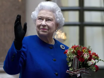 FILE - In this Tuesday, Dec. 18, 2012 file photo, Britain's Queen Elizabeth II looks up and waves to members of staff of The Foreign and Commonwealth Office as she ends an official visit which is part of her Jubilee celebrations in London. Queen Elizabeth II, Britain's longest-reigning monarch and a symbol of stability across much of a turbulent century, has died on Thursday, Sept, 8, 2022. She was 96. (AP Photo/Alastair Grant Pool, File)