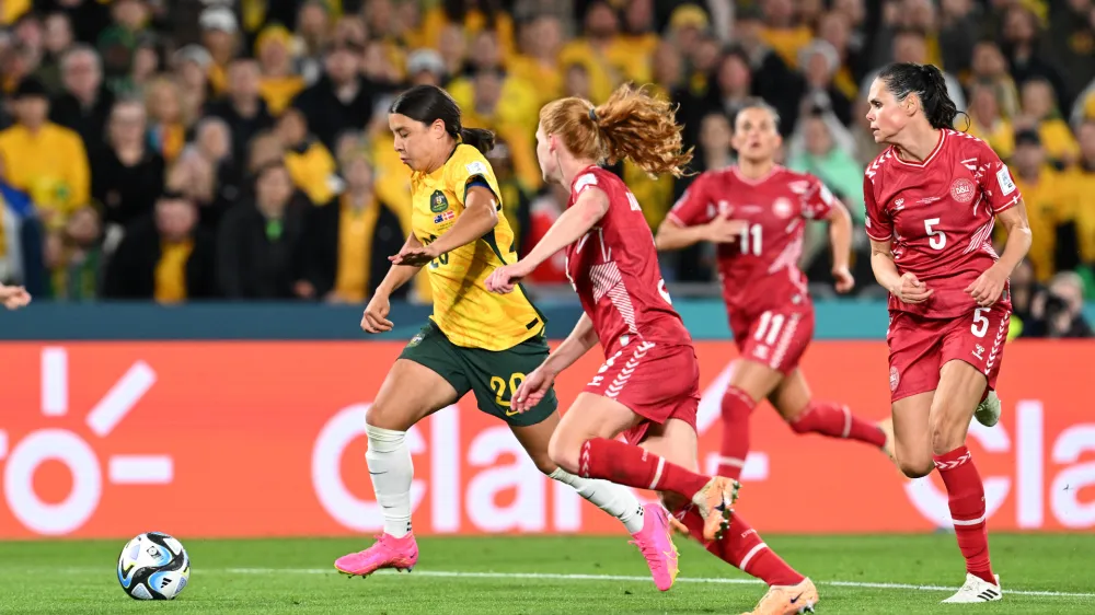 Sam Kerr of Australia (left) in action during the FIFA Women's World Cup 2023 Round of 16 soccer match between Australia and Denmark at Stadium Australia in Sydney, Monday, August 7, 2023. (AAP Image/Dean Lewins) NO ARCHIVING, EDITORIAL USE ONLY