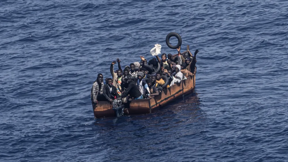 PRODUCTION - 29 June 2023, Italy, Lampedusa: Migrants trying to reach the Italian island of Lampedusa from the northern coast of Africa are apparently adrift in the Mediterranean Sea with engine trouble. More and more African refugees are crossing to Italy from Tunisia. Many migrants pay a high price for the journey, not only financially. Photo: Oliver Weiken/dpa