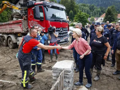 European Commission President Ursula von der Leyen, center right, visits Crna, Slovenia, Wednesday Aug. 9, 2023, ravaged by recent floods that killed at least six people and caused extensive damage. Slovenian officials have described last week's floods as the worst natural disaster in the country's 32-year history. (Anze Malovrh/STA via AP)