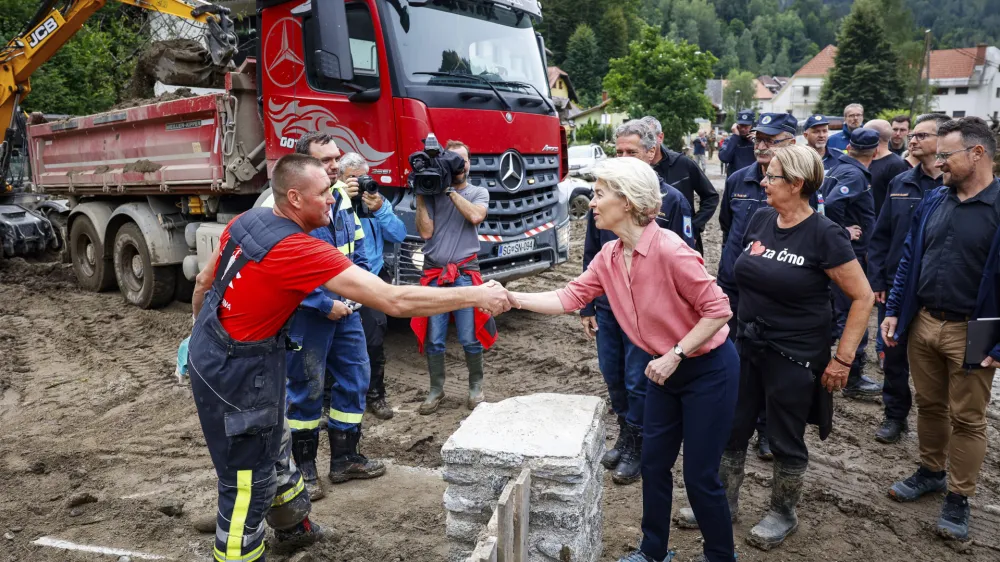 European Commission President Ursula von der Leyen, center right, visits Crna, Slovenia, Wednesday Aug. 9, 2023, ravaged by recent floods that killed at least six people and caused extensive damage. Slovenian officials have described last week's floods as the worst natural disaster in the country's 32-year history. (Anze Malovrh/STA via AP)