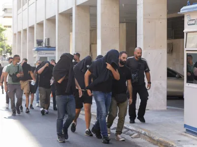 Soccer fans detained following violent clashes between AEK Athens and Dinamo Zagreb soccer fans, that lead to the death of a man, are taken to a magistrate, in Athens, Greece, August 11, 2023. REUTERS/Louiza Vradi