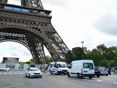 12 August 2023, France, Paris: Officers of the riot police (CRS) secure an area in the center of Paris after a security alert because a bomb threat resulted in the evacuation of three floors of the Eiffel Tower. About 4,000 people had to leave the landmark and the forecourt on Saturday, police sources told Deutsche Presse-Agentur. Photo: Miguel Medina/AFP/dpa