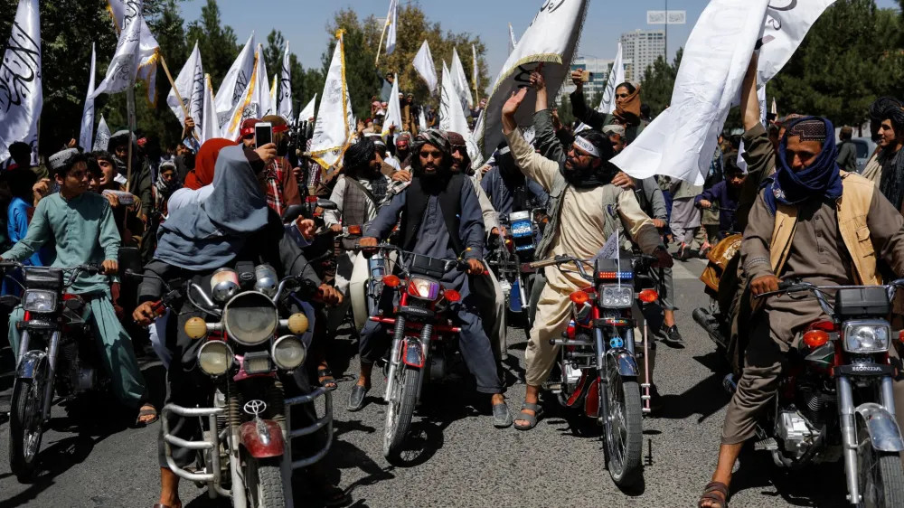 Taliban members celebrate on the second anniversary of the fall of Kabul on a street near the US embassy in Kabul, Afghanistan, August 15, 2023. REUTERS/Ali Khara