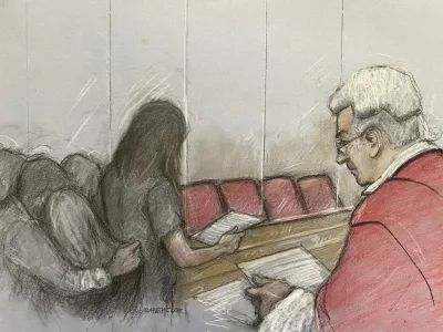 This court artist drawing by Elizabeth Cook of the parent of one of Lucy Letby's victims reading a victim impact statement at Manchester Crown Court in Manchester, England, Monday, Aug. 21, 2023. A judge is set to sentence Lucy Letby for murdering seven babies and attempting to kill six others while working as a neonatal nurse at a hospital in northern England. Justice James Goss on Monday could level the most severe sentence possible under British law by imposing a whole-life order to ensure that Letby will spend the rest of her life behind bars. (Elizabeth Cook/PA via AP)