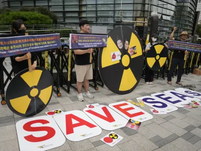 Members of environmental civic groups shout slogans during a rally to denounce the Japanese government's decision to release treated radioactive water into the sea from the damaged Fukushima nuclear power plant, outside of a building which houses Japanese Embassy, in Seoul, South Korea, Tuesday, Aug. 22, 2023. Japan will start releasing treated and diluted radioactive wastewater from the Fukushima Daiichi nuclear plant into the Pacific Ocean as early as Thursday, a controversial but essential early step in the decades of work to shut down the facility 12 years after its meltdown disaster. (AP Photo/Lee Jin-man)