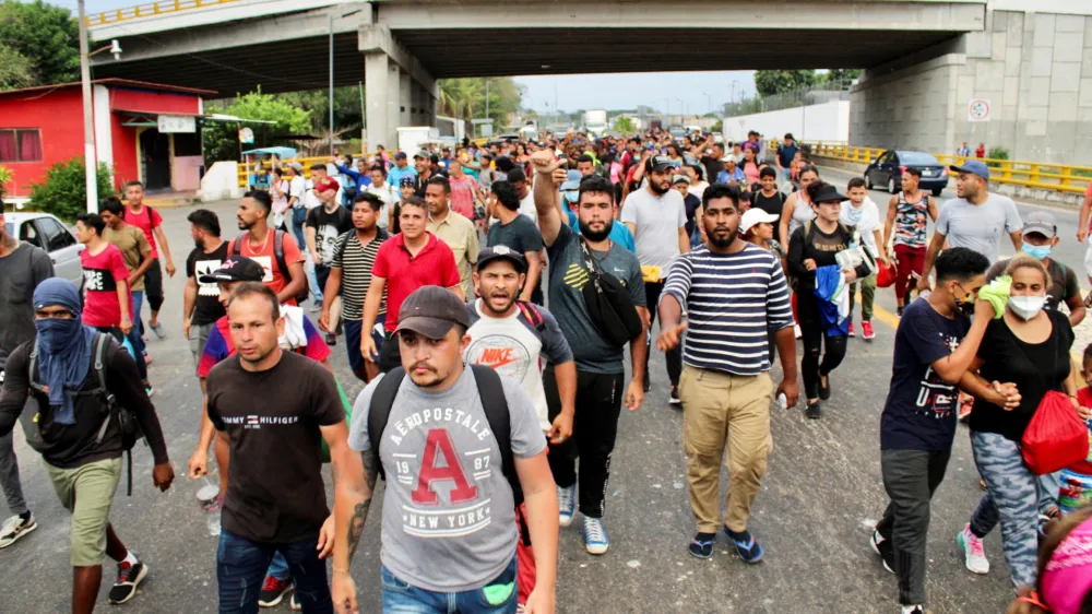 Migrants stranded in Tapachula take part in a caravan towards the U.S. after growing impatient of waiting for the humanitarian visa to cross the country, in Tapachula, Mexico April 26, 2022. REUTERS/Jose Torres