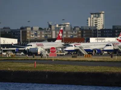 Airplanes are grounded at London City Airport, in London, Monday, Aug. 28, 2023. Britain's air traffic control system says it has fixed a "technical issue" that caused heavy delays and cancellations. National Air Traffic Services says it has "identified and remedied" a problem that meant flight plans had to be input manually for several hours on Monday. (AP Photo/Alberto Pezzali)