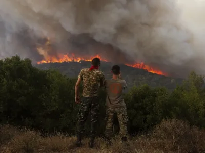 FILE - Flames burn a forest during wildfires near the village of Sykorrahi, near Alexandroupolis town, in the northeastern Evros region, Greece, Wednesday, Aug. 23, 2023. Greek authorities have further reinforced firefighting forces in the country's northeast, where a massive blaze in its thirteenth day has flared up once more, triggering authorities to issue alerts to residents in the area to be on standby for possible evacuation. (AP Photo/Achilleas Chiras, file)