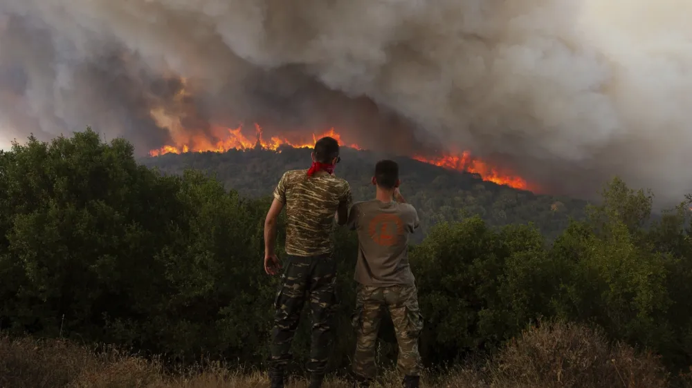 FILE - Flames burn a forest during wildfires near the village of Sykorrahi, near Alexandroupolis town, in the northeastern Evros region, Greece, Wednesday, Aug. 23, 2023. Greek authorities have further reinforced firefighting forces in the country's northeast, where a massive blaze in its thirteenth day has flared up once more, triggering authorities to issue alerts to residents in the area to be on standby for possible evacuation. (AP Photo/Achilleas Chiras, file)