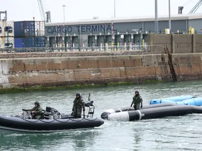 Military personnel tow dinghies used by migrant to cross the English Channel into Dover Harbour in Dover, Britain, May 1, 2022. REUTERS/Henry Nicholls