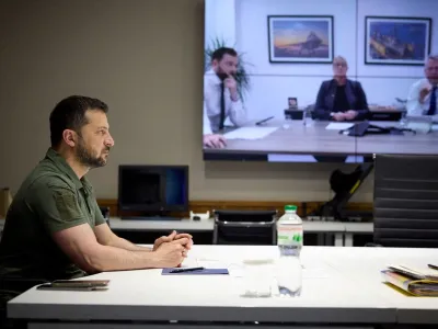 FILE PHOTO: Ukraine's President Volodymyr Zelenskiy speaks with representatives of the British defense company BAE Systems – CEO Charles Woodburn, Managing Director Gabby Costigan and Director for cooperation with Ukraine Christian Seear via video call, amid Russia's attack on Ukraine, in Kyiv, Ukraine, in this handout picture released May 30, 2023. Ukrainian Presidential Press Service/Handout via REUTERS ATTENTION EDITORS - THIS IMAGE HAS BEEN SUPPLIED BY A THIRD PARTY. MANDATORY CREDIT./File Photo