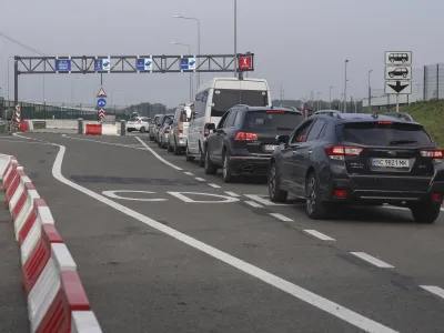 FILE - Cars queue towards Poland at the Krakovets - Korcheva border crossing point in Krakovets, Ukraine, Tuesday, Aug. 16, 2022. Poland has begun enforcing an entry ban on all Russian-registered passenger cars seeking to enter the country. The move comes just days after the nearby Baltic states of Lithuania, Latvia and Estonia banned vehicles with Russian license plates from entering their territory. (AP Photo/Roman Baluk, File)