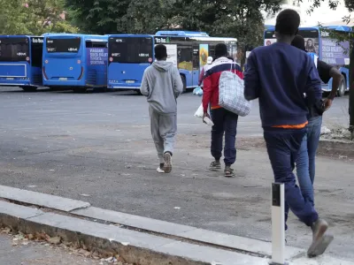 Migrants walk towards a station to board a bus directed to Marseille, France, in Rome, Tuesday, Sept. 12, 2023. Ten years after Pope Francis made a landmark visit to the Italian island of Lampedusa to show solidarity with migrants, he is joining Catholic bishops from around the Mediterranean this weekend in France to make the call more united, precisely at the moment that European leaders are again scrambling to stem the tide of would-be refugees setting off from Africa. (AP Photo/Gregorio Borgia)