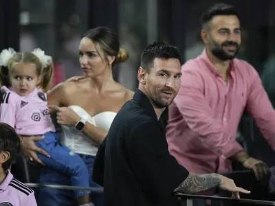 Inter Miami forward Lionel Messi, front, greets friends inside a private box at the start of the team's U.S. Open Cup final soccer match against the Houston Dynamo, Wednesday, Sept. 27, 2023, in Fort Lauderdale, Fla. (AP Photo/Rebecca Blackwell)