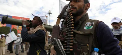 A Houthi follower holds a machine gun with ammunition belt during a parade in a show of force amid a standoff in the Red Sea and U.S.-led airstrikes on Houthi targets, in Sanaa, Yemen, February 8, 2024. REUTERS/Khaled Abdullah