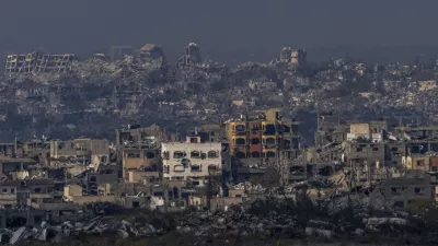 Destroyed buildings by Israeli bombardments as seen inside the Gaza Strip from southern Israel, Thursday, Jan. 16, 2025. (AP Photo/Ariel Schalit)