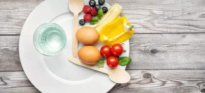 Interval fasting diet. Intermittent fasting concept represented with a plate and products on gray background. Healthy lifestyle. Fat loss concept. Top view