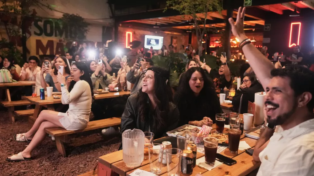 Fans gather to celebrate the release of Taylor Swift's new album, "The Life of a Showgirl" in Mexico City, Thursday, Oct. 2, 2025. (AP Photo/Claudia Rosel)