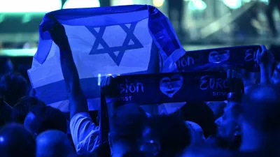 17 May 2025, Switzerland, Basel: A person holds an Israeli flag during the Grand Final of the Eurovision Song Contest 2025 in Basel. The European Broadcasting Union (EBU), which organizes Eurovision, said on Thursday that it will hold an online meeting in November to vote on participation in the 2026 contest, as debate over Israel's involvement continues to stir controversy. Photo: Heikki Saukkomaa/Lehtikuva/dpa