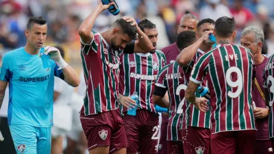 FILE - Fluminense players cooling up during a water break at the Club World Cup quarterfinal soccer match between Fluminense and Al Hilal in Orlando, Fla., Friday, July 4, 2025. (AP Photo/John Raoux, file)