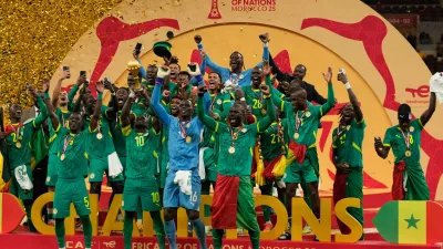 Senegalese players celebrate after winning the Africa Cup of Nations final soccer match agaisnt Morocco, in Rabat, Morocco, Sunday, Jan. 18, 2026. (AP Photo/Mosa'ab Elshamy)