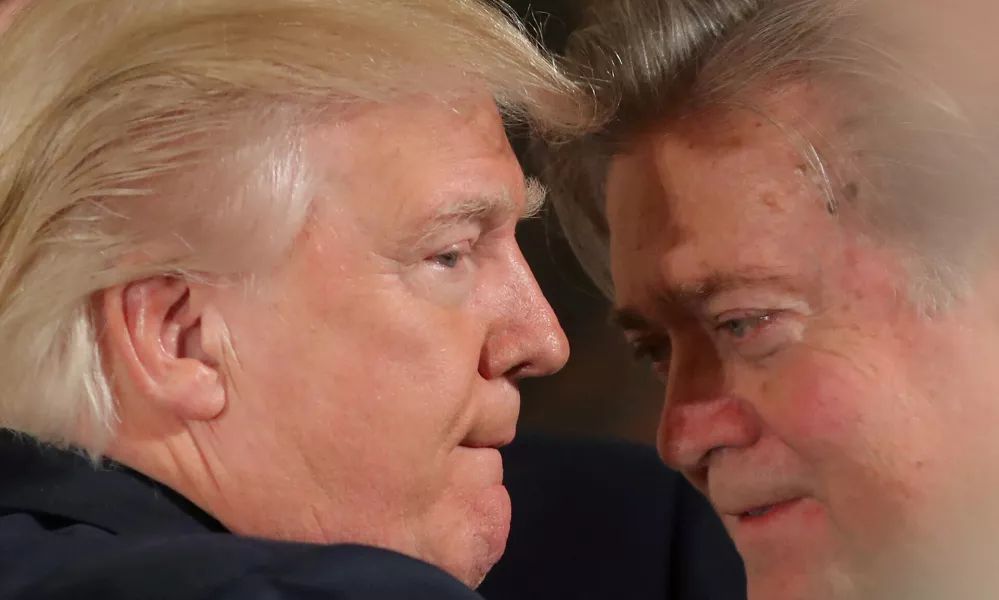 FILE PHOTO: U.S. President Donald Trump talks to chief strategist Steve Bannon during a swearing in ceremony for senior staff at the White House in Washington, U.S. January 22, 2017. REUTERS/Carlos Barria/File Photo